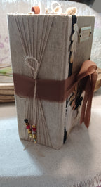 Thick handmade Autumn Remembered junk journal showing wrapped binding and layered pages