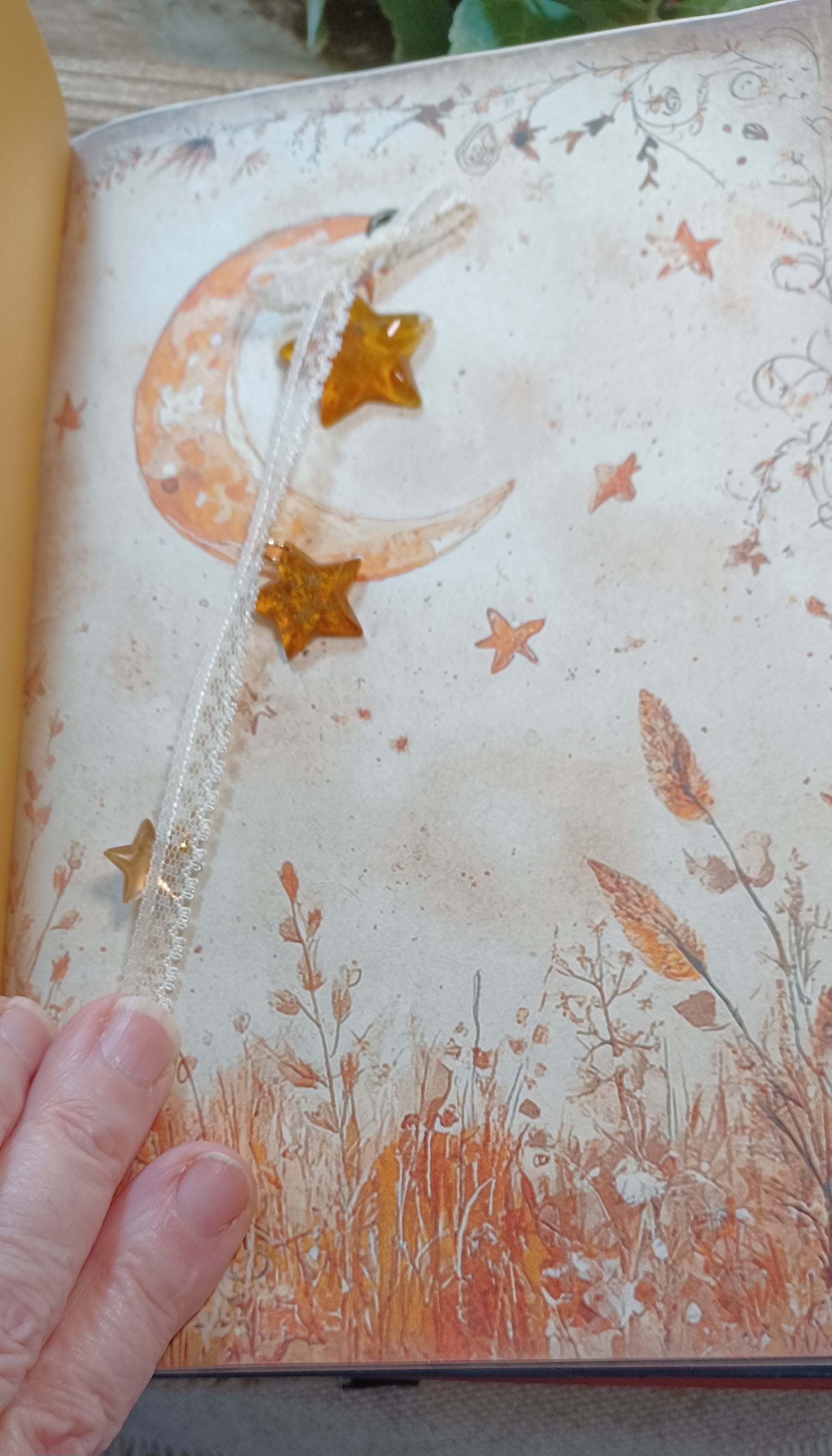 Gold mercury-glass-style resin star charm embellishment on a handmade autumn journal