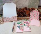 Pink Christmas notepads with handmade pockets, ribbon, lace and holiday ephemera