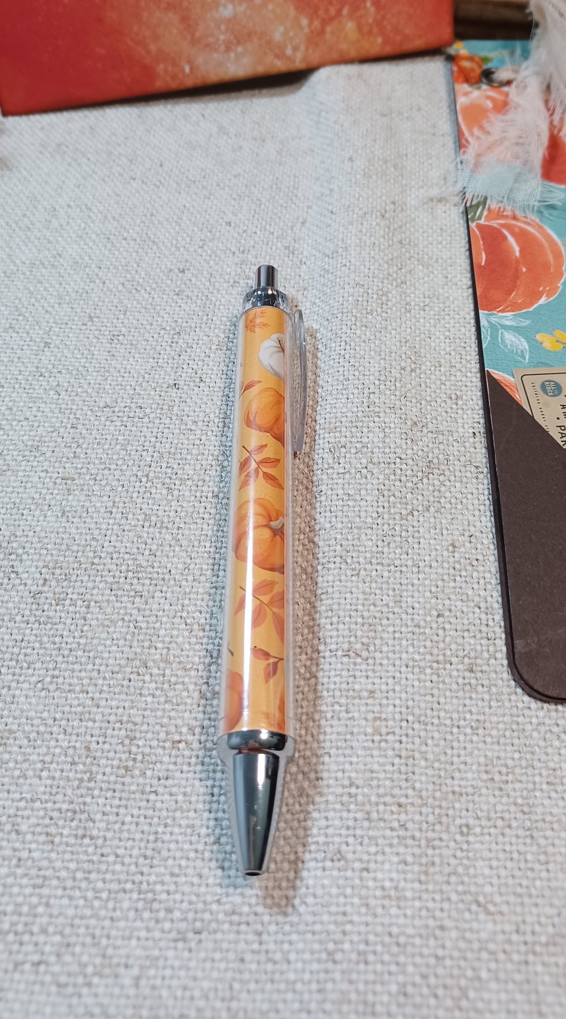 Coordinating autumn pumpkin pen included with handmade journal set