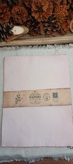 Pack of avocado-dyed paper in dusty pink tones wrapped with Butterfly in the Attic paper band