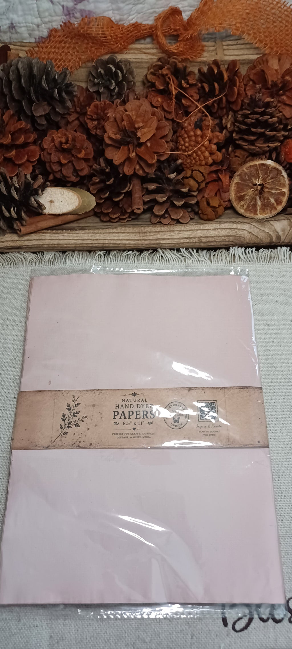Packaged 10-sheet set of naturally avocado-dyed paper from Wander Through the Paper Garden