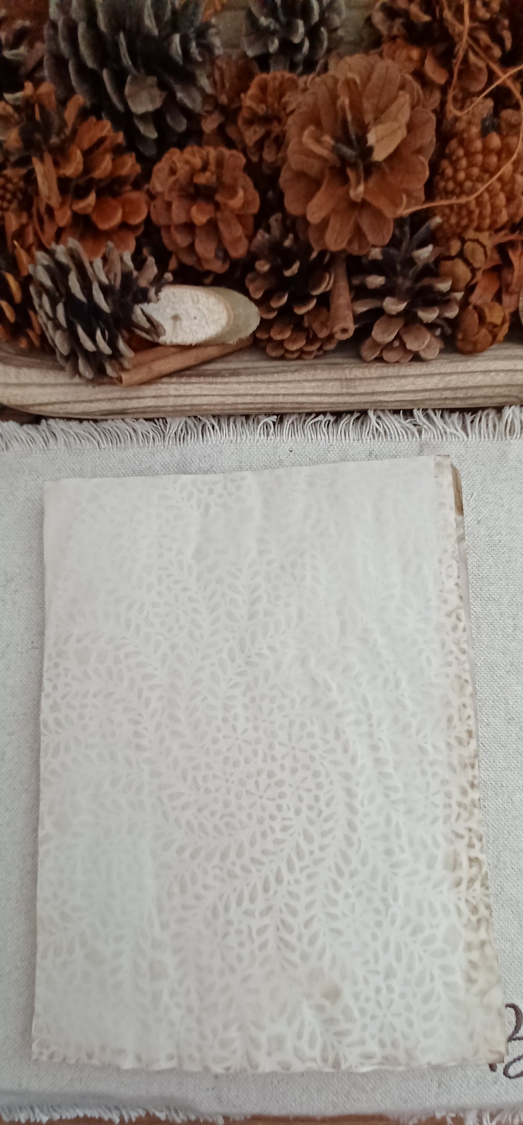 Tea-dyed paper showing hand-created stencil pattern and natural color variation