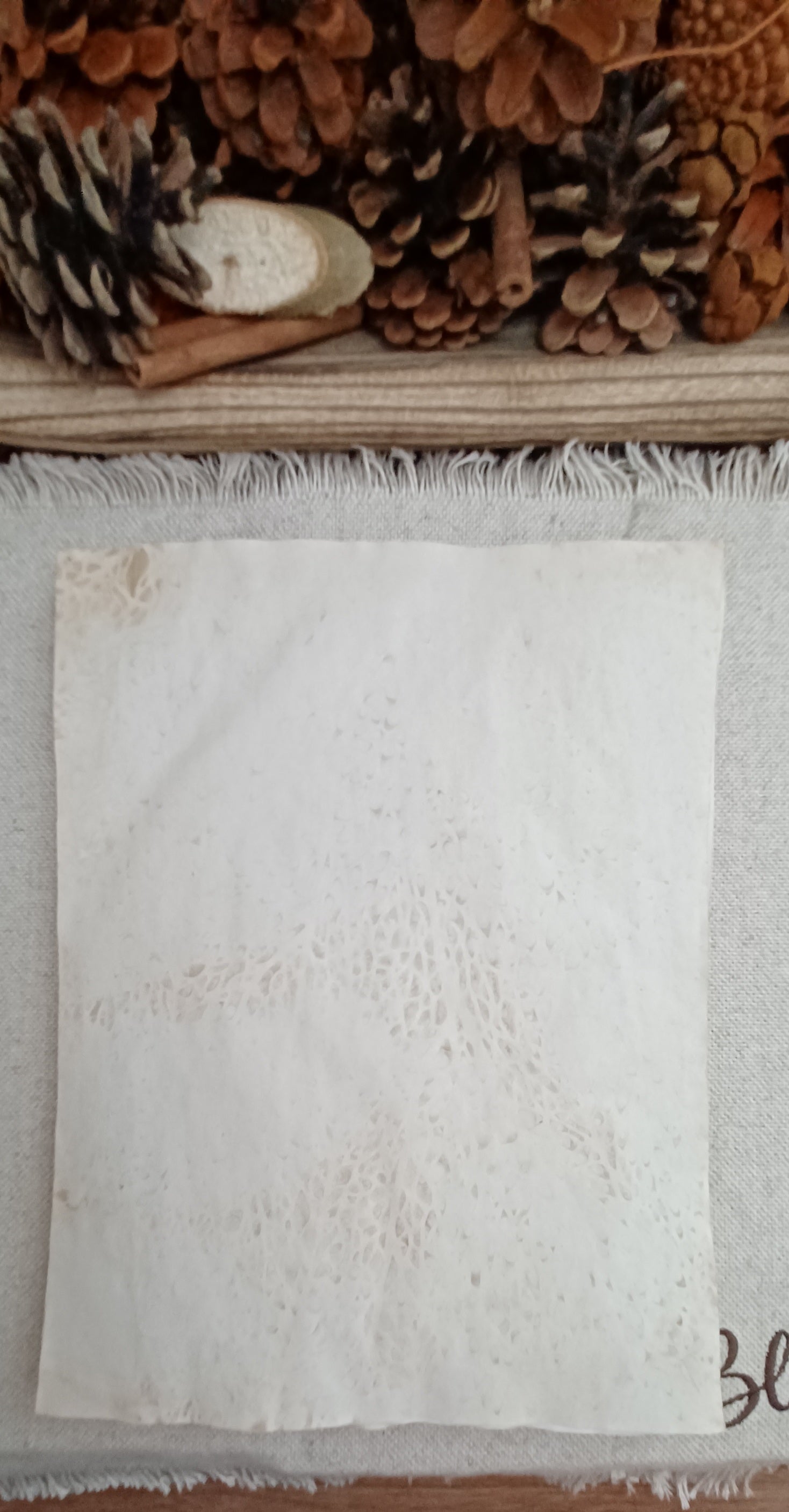 Close view of organic markings and texture on naturally hand-dyed tea paper