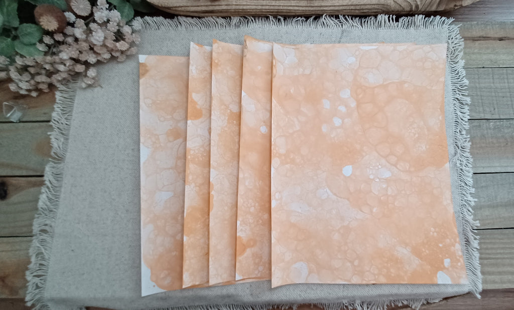 Five Dark Orange bubble-blown 8.5 x 11 paper sheets fanned out to show varied handmade bubble patterns