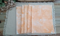 Five Dark Orange bubble-blown 8.5 x 11 paper sheets fanned out to show varied handmade bubble patterns