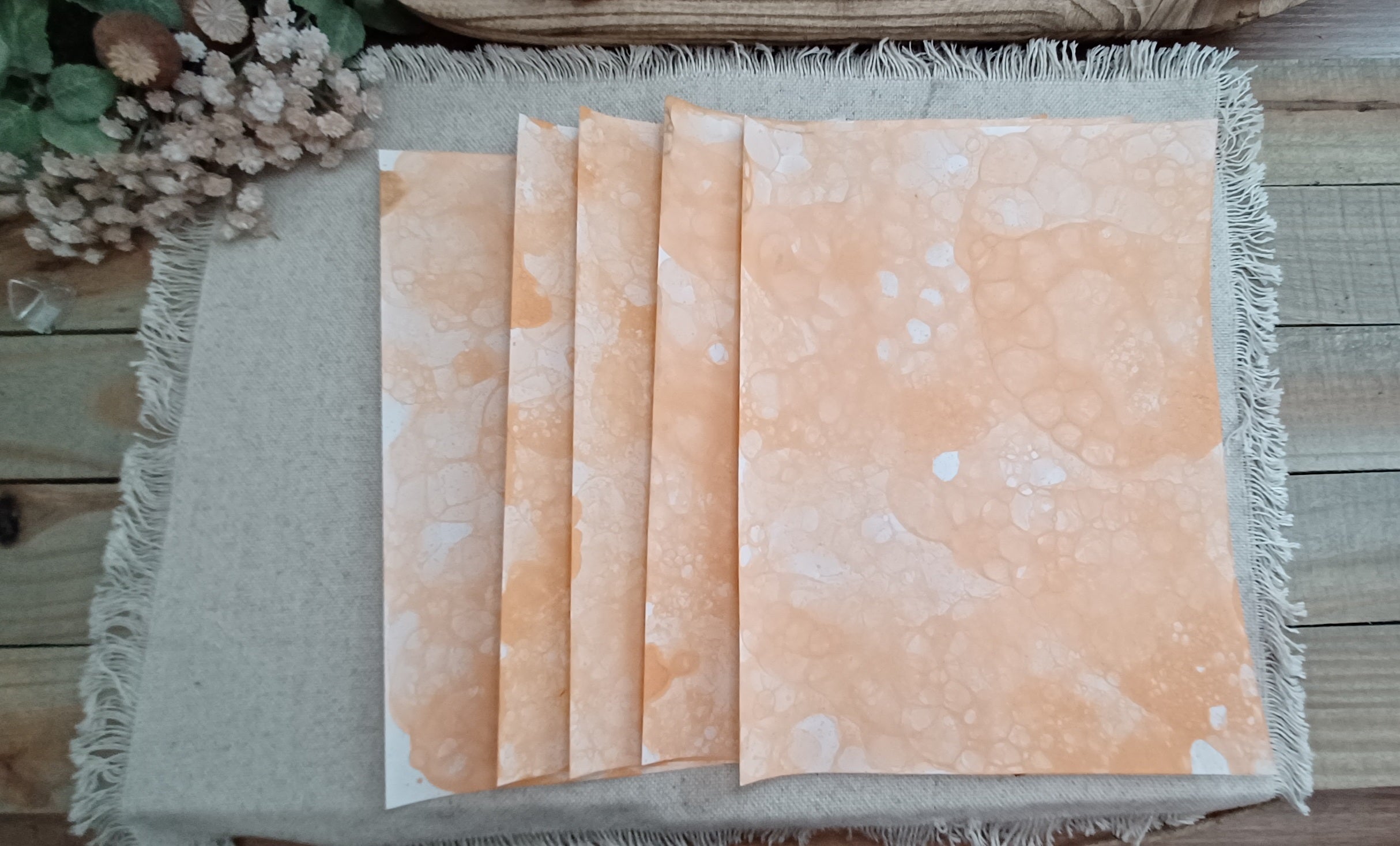Five Dark Orange bubble-blown 8.5 x 11 paper sheets fanned out to show varied handmade bubble patterns