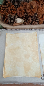 Mustard hand-patterned paper with softly mottled color and varied bubble clusters created by blown bubbles