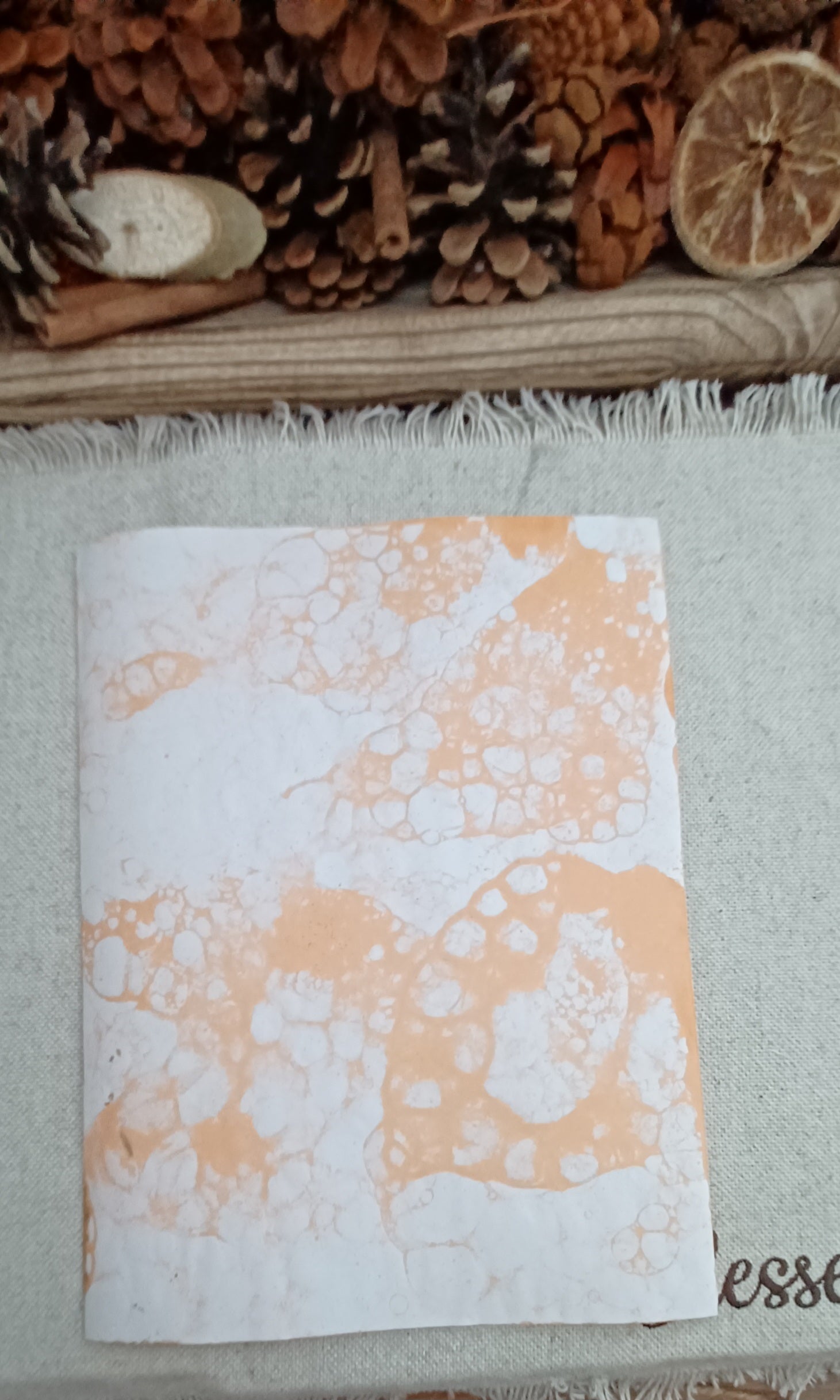 Backside of paper with large open circles and clusters of smaller organic bubble patterns
