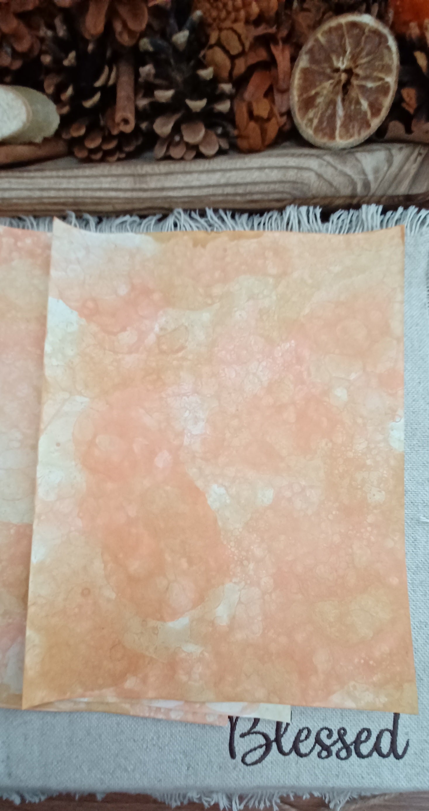 Handmade Orange and Mustard decorative paper with mottled warm color, pale areas, and overlapping bubble impressions
