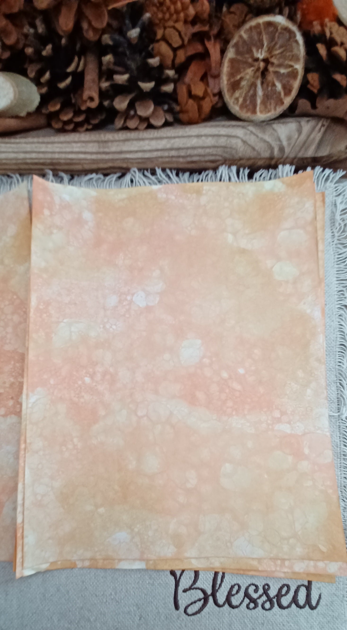 Handmade Orange and Mustard paper with soft blended color and subtle organic patterns created by blown bubbles