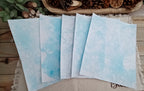 Five Light Blue bubble-blown 8.5 x 11 paper sheets fanned out to show varied handmade bubble patterns