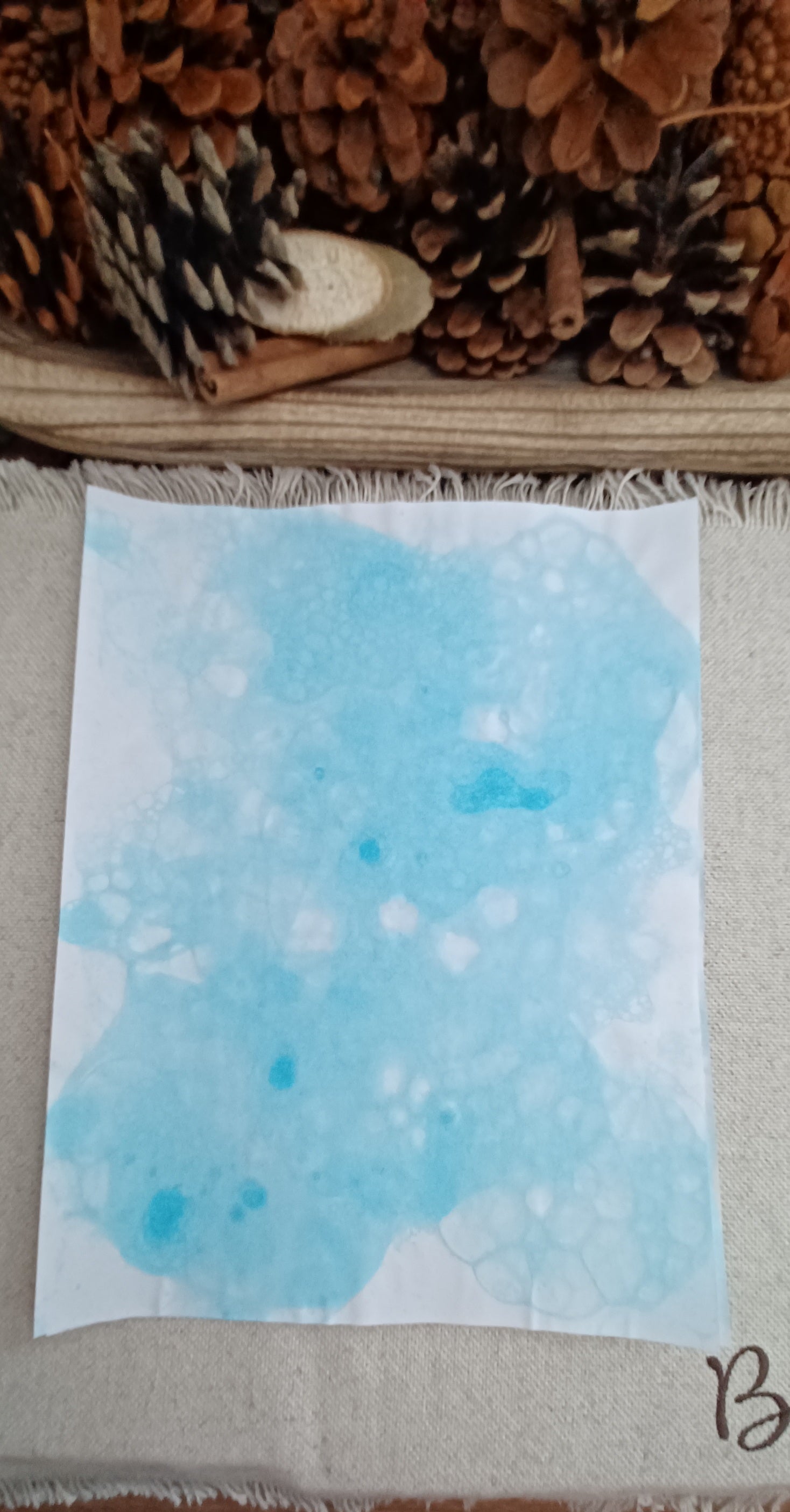 Handmade Light Blue bubble art paper showing brighter aqua areas, overlapping circles, and organic bubble patterns