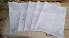 Five Purple bubble-blown 8.5 x 11 paper sheets fanned out to show varied handmade bubble patterns