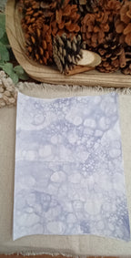 Hand-patterned Purple art paper showing large and small organic bubble rings created by the bubble-blowing process