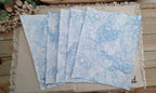 Five 8.5 x 11 Denim Blue bubble-blown paper sheets fanned out to show unique handmade bubble patterns
