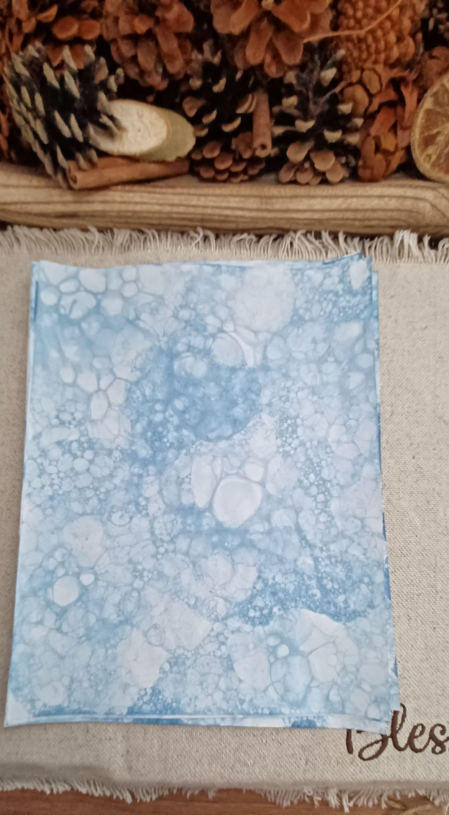 Close-up of handmade Denim Blue bubble art paper with large and small overlapping circular bubble impressions