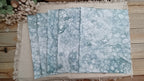 Five Green bubble-blown 8.5 x 11 paper sheets fanned out to show varied handmade bubble patterns