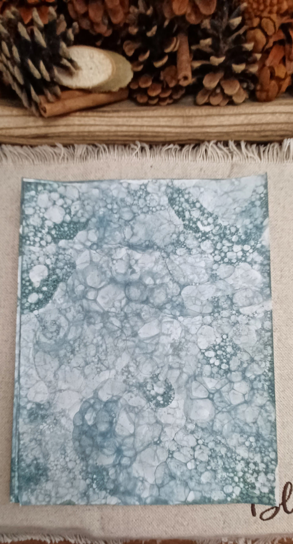 Green bubble-blown decorative paper with large open circles and intricate clusters of tiny overlapping bubbles