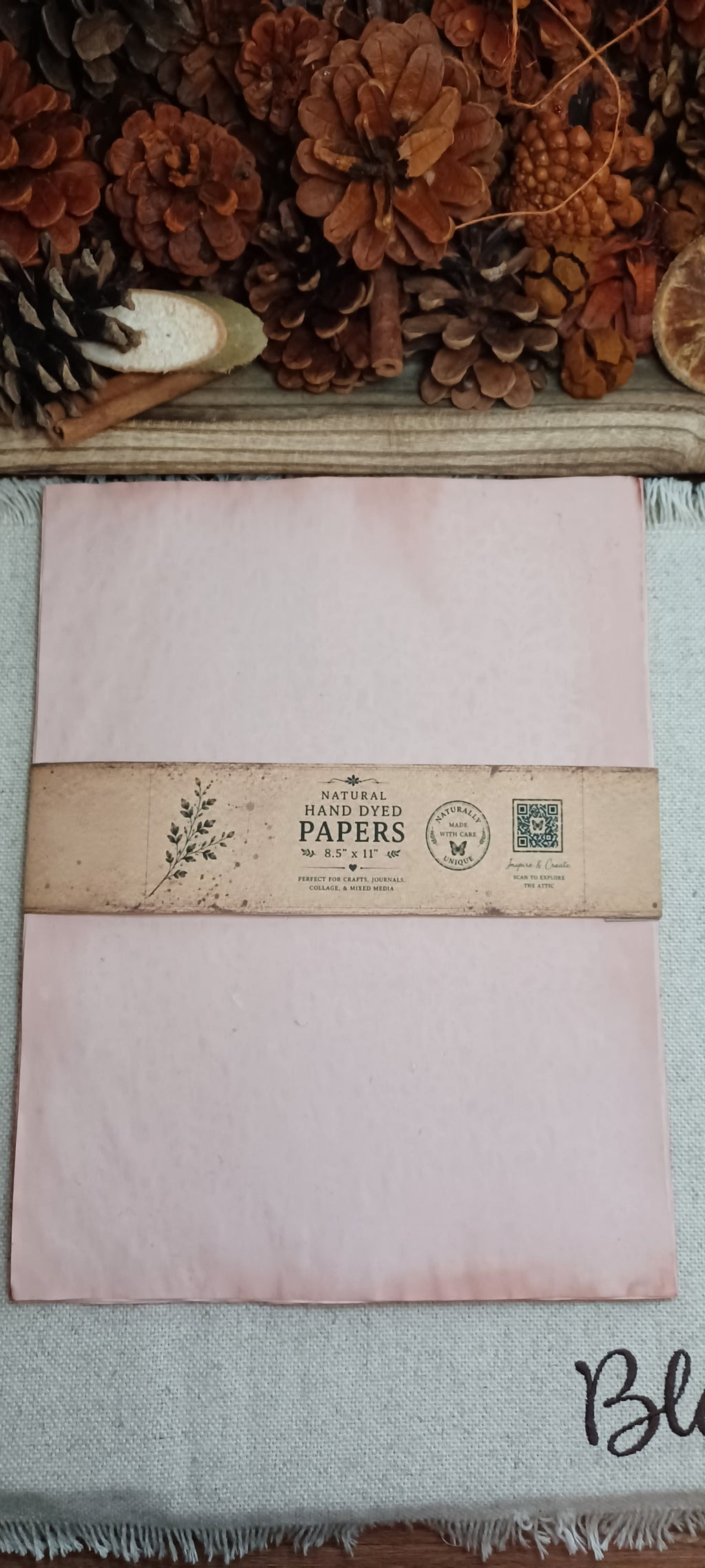 Packaged 10-sheet set of naturally avocado-dyed paper from Wander Through the Paper Garden