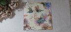 Vintage-style butterfly and floral luncheon paper napkin with soft sage green, blue, lavender and blush flowers for decoupage and paper crafts.