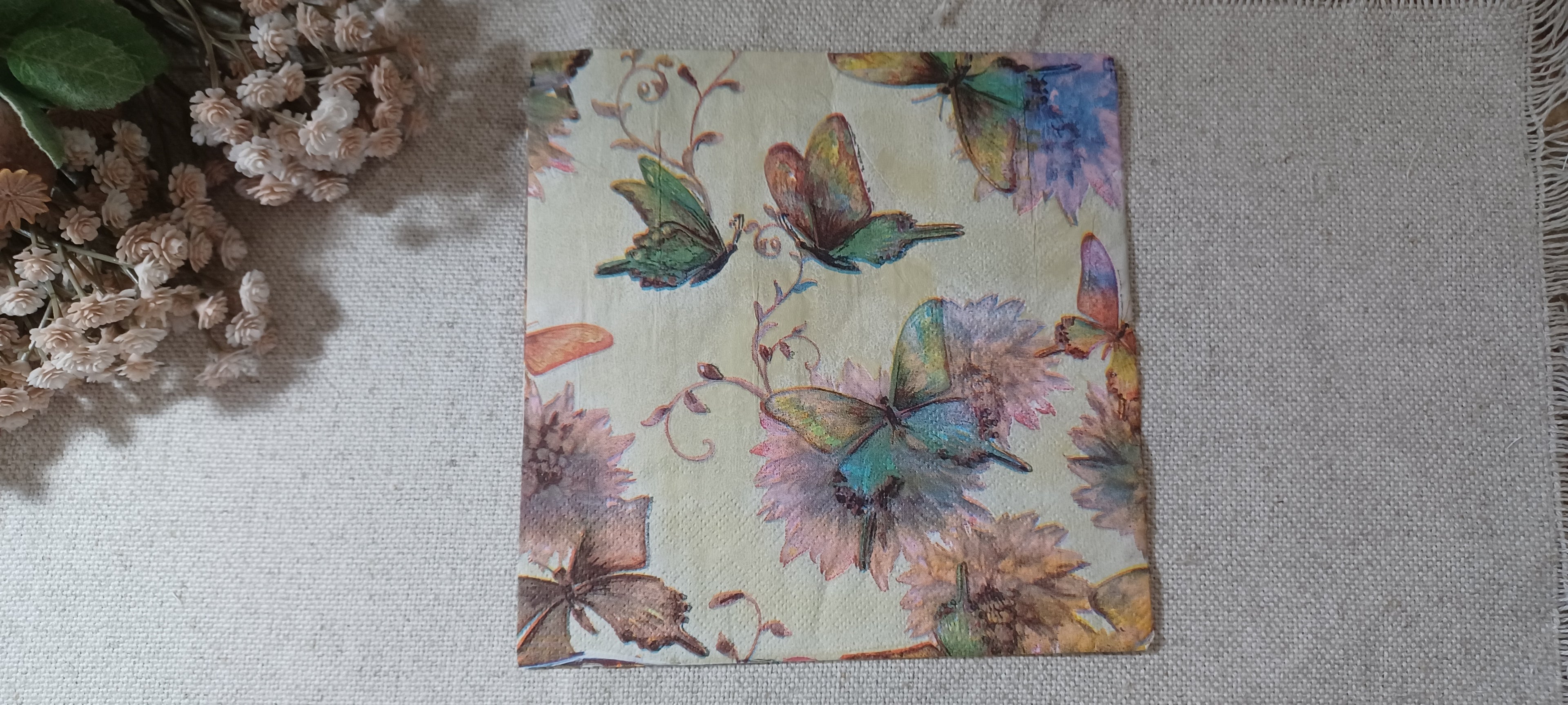 Vintage-style butterfly and floral luncheon paper napkin with soft sage green, blue, lavender and blush flowers for decoupage and paper crafts.