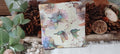 Vintage-style butterfly and floral luncheon paper napkin with soft sage green, blue, lavender and blush flowers for decoupage and paper crafts.