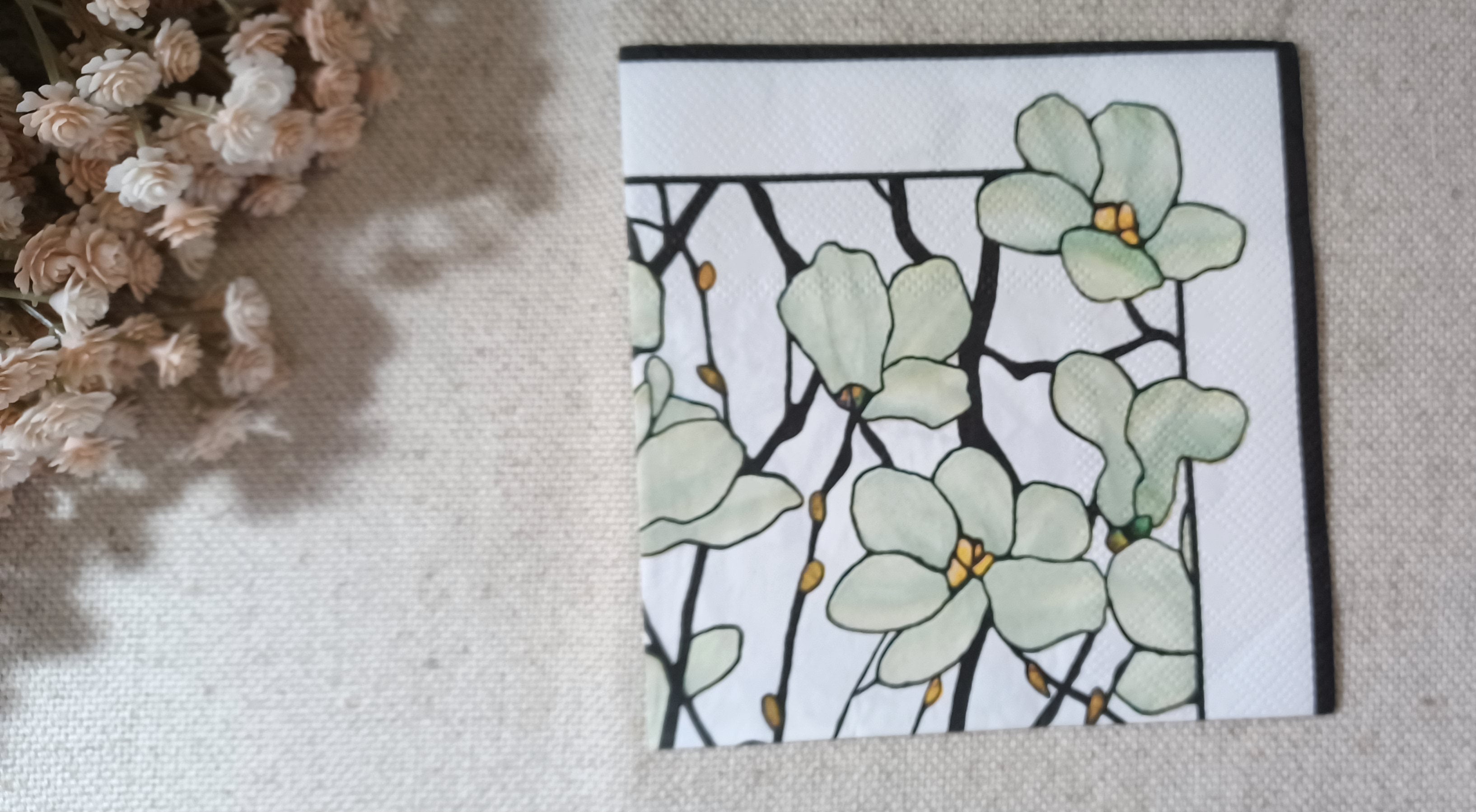 Sage green floral cocktail paper napkin with black botanical branches and golden accents for decoupage, collage and paper crafts.