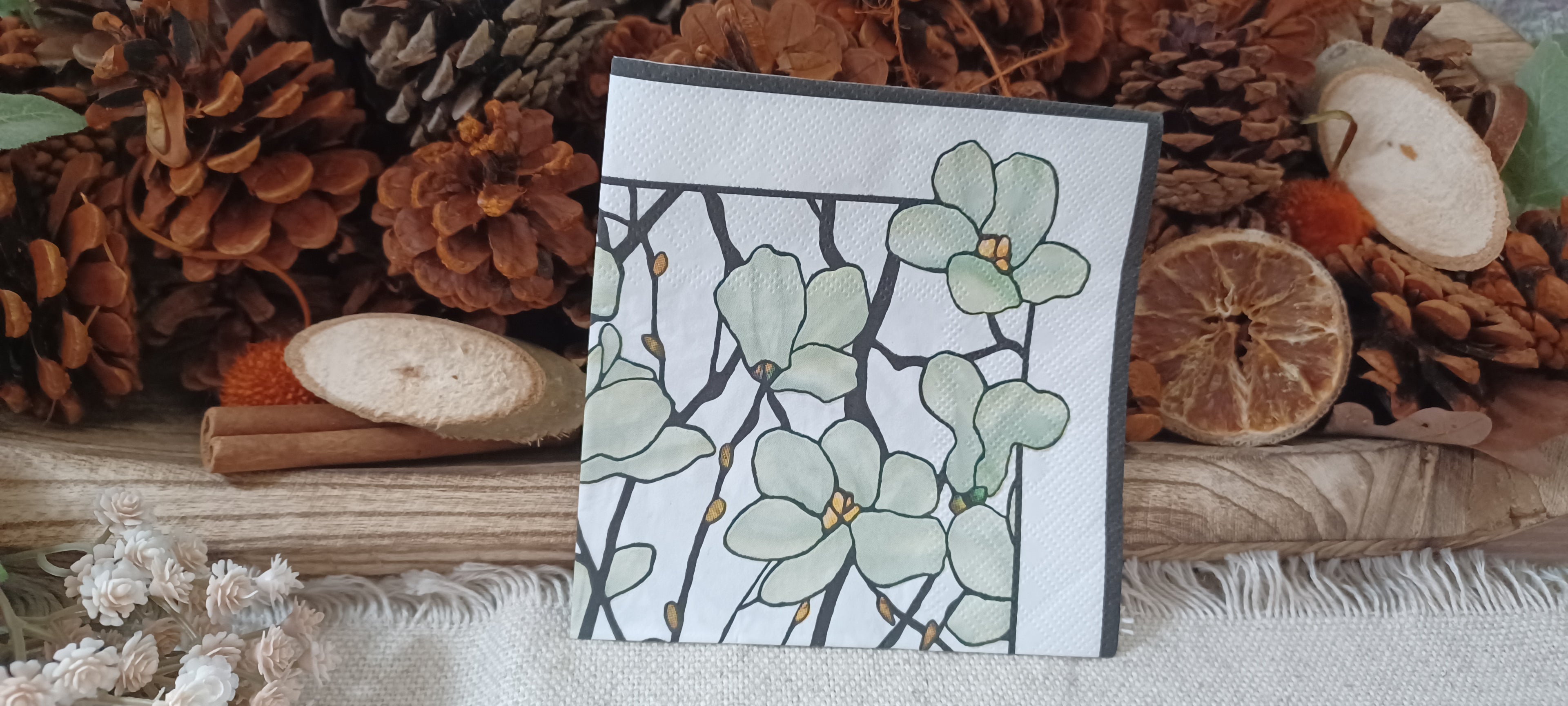 Sage green floral cocktail paper napkin with black botanical branches and golden accents for decoupage, collage and paper crafts.
