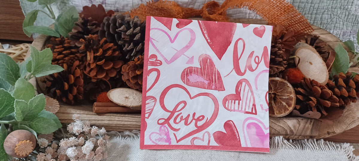 Watercolor hearts and Love decoupage paper napkin displayed against a rustic botanical background.