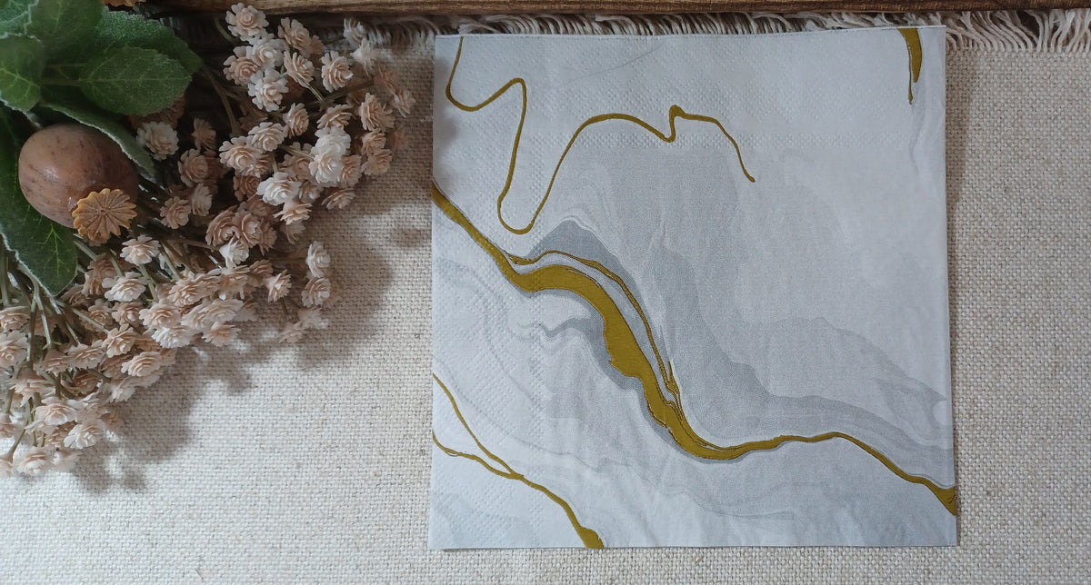 White and pale gray marble paper napkin with flowing gold accents, 13 x 13 inch luncheon size.