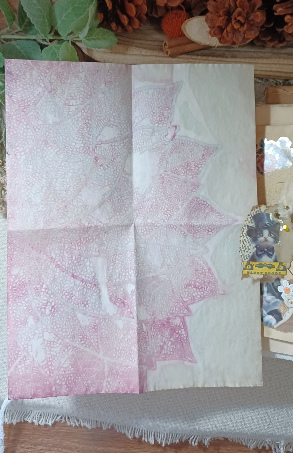 Soft pink page inside handmade vintage cat journal with layered lace and decorative details.