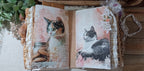 Decorative corner and page-edge embellishments inside the lace-filled handmade cat junk journal.