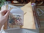 Open vintage-style cat junk journal with kitten imagery, pockets, lace and layered handmade pages.