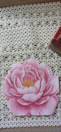 Pink die-cut floral luncheon napkin displayed on vintage crochet lace for decoupage and paper crafts.