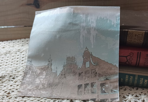 Alternate architectural scene on vintage-style decoupage napkin with old buildings in pale blue and sepia tones.