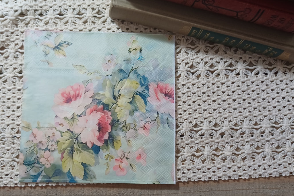 Full luncheon decoupage napkin with soft pink flowers, blue-green leaves, and a pale aqua watercolor background.