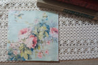 Full luncheon decoupage napkin with soft pink flowers, blue-green leaves, and a pale aqua watercolor background.