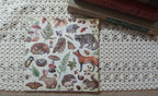 Full woodland decoupage napkin featuring forest animals, mushrooms, ferns, berries, butterflies, and other nature motifs.