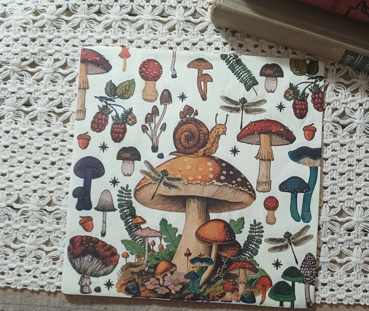 Full woodland mushroom decoupage napkin with snail, dragonflies, colorful toadstools, ferns, berries, and acorns.