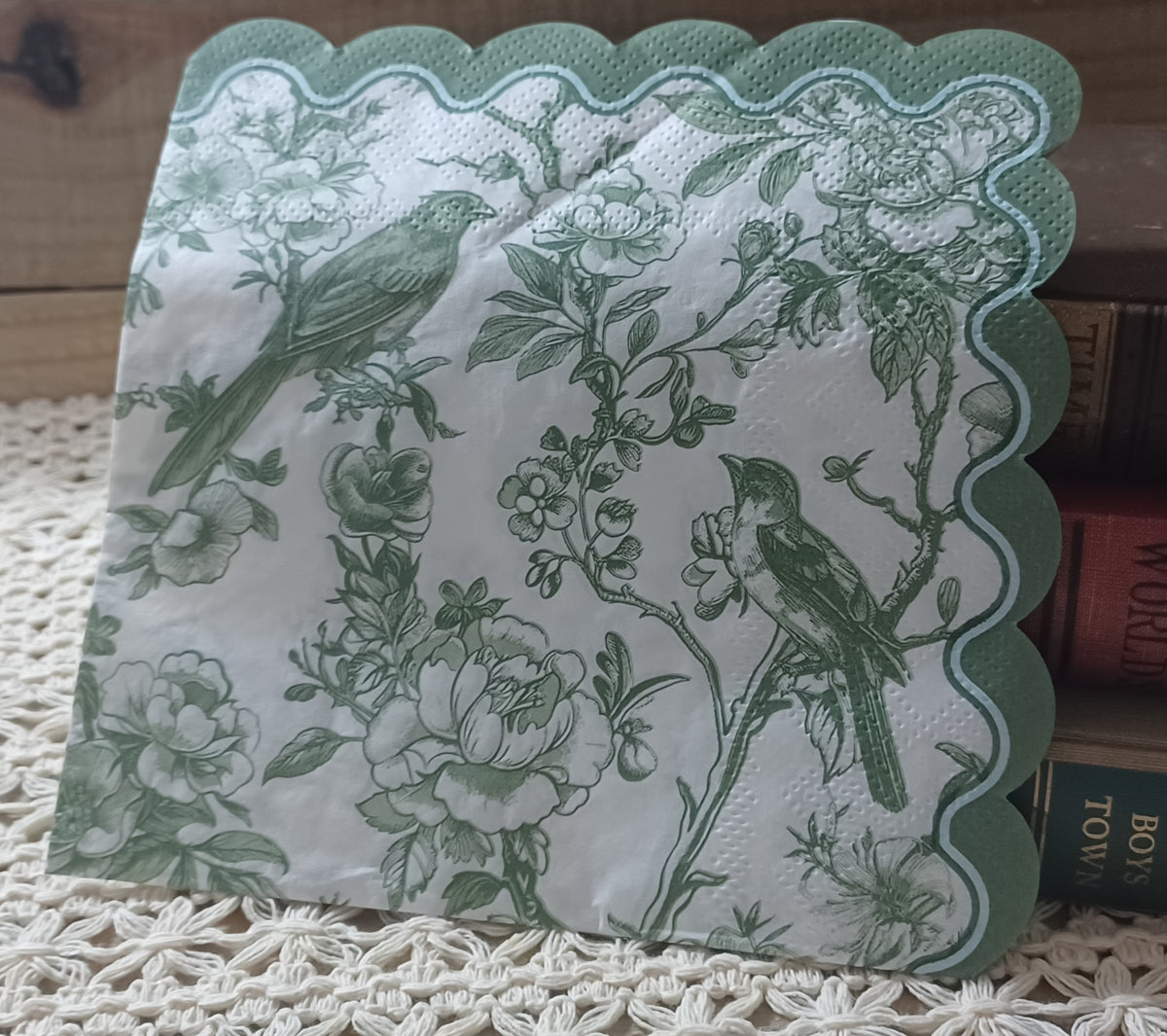 Sage green bird and floral decoupage napkin with vintage-style roses, botanical branches, and scalloped border.