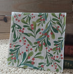 Full luncheon paper napkin with watercolor green leafy branches and red berries on a white background.