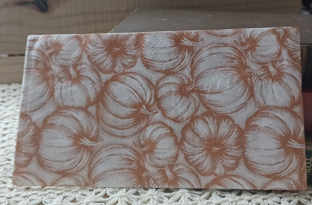 Single vintage-style pumpkin paper guest towel featuring an all-over pattern of illustrated pumpkins in warm terracotta-brown on white.