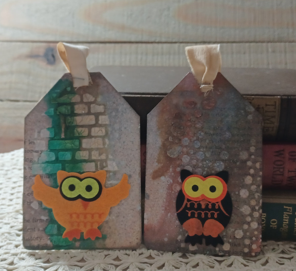 Orange and black owl journal tags with teal brick-like texture, faded book text and weathered mixed-media layers