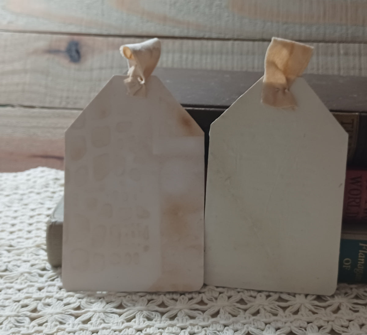 Close view of handmade Halloween owl tags with distressed wall textures and layered vintage paper