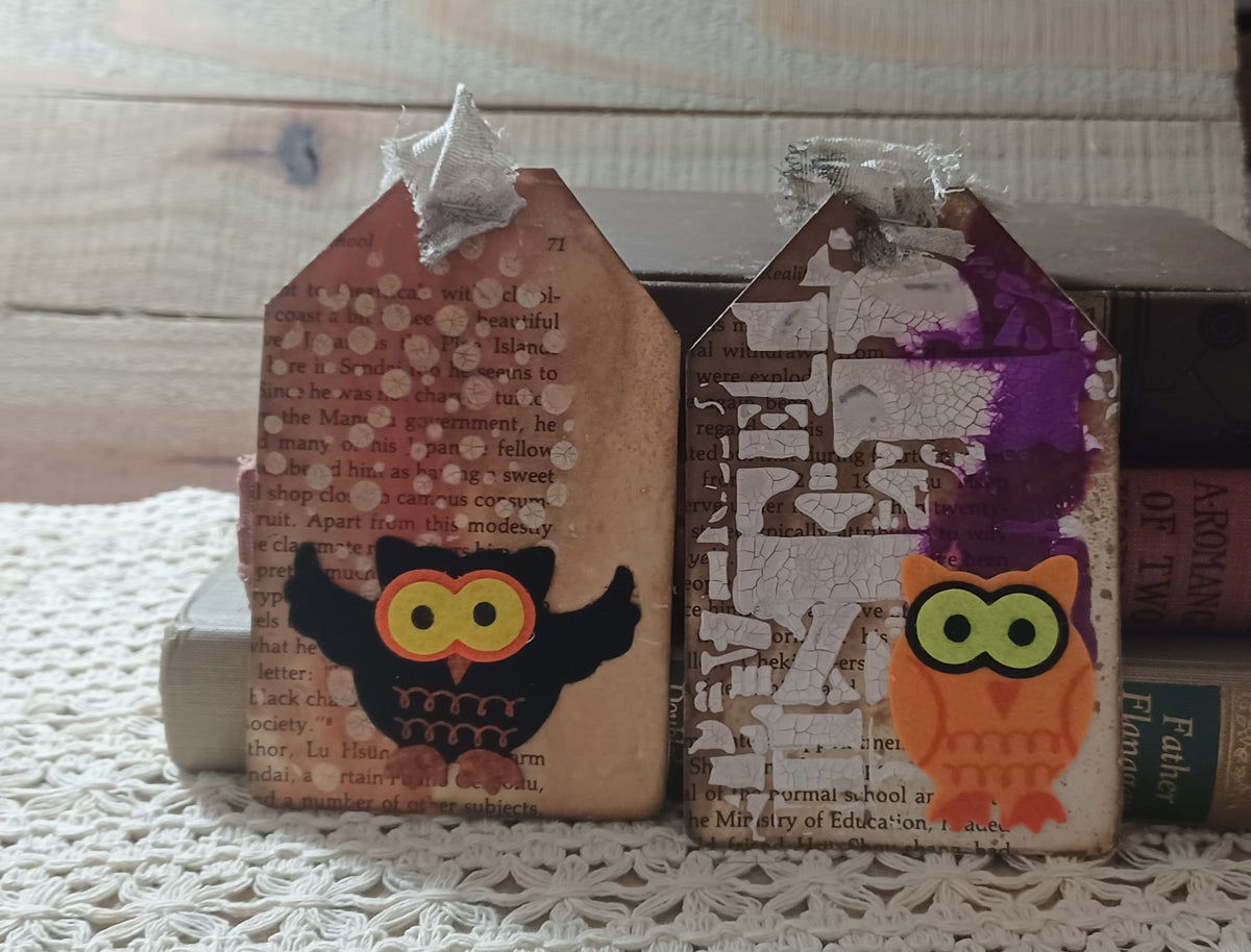 Black and orange owl tags layered over vintage book text with distressed ivory and purple mixed-media texture