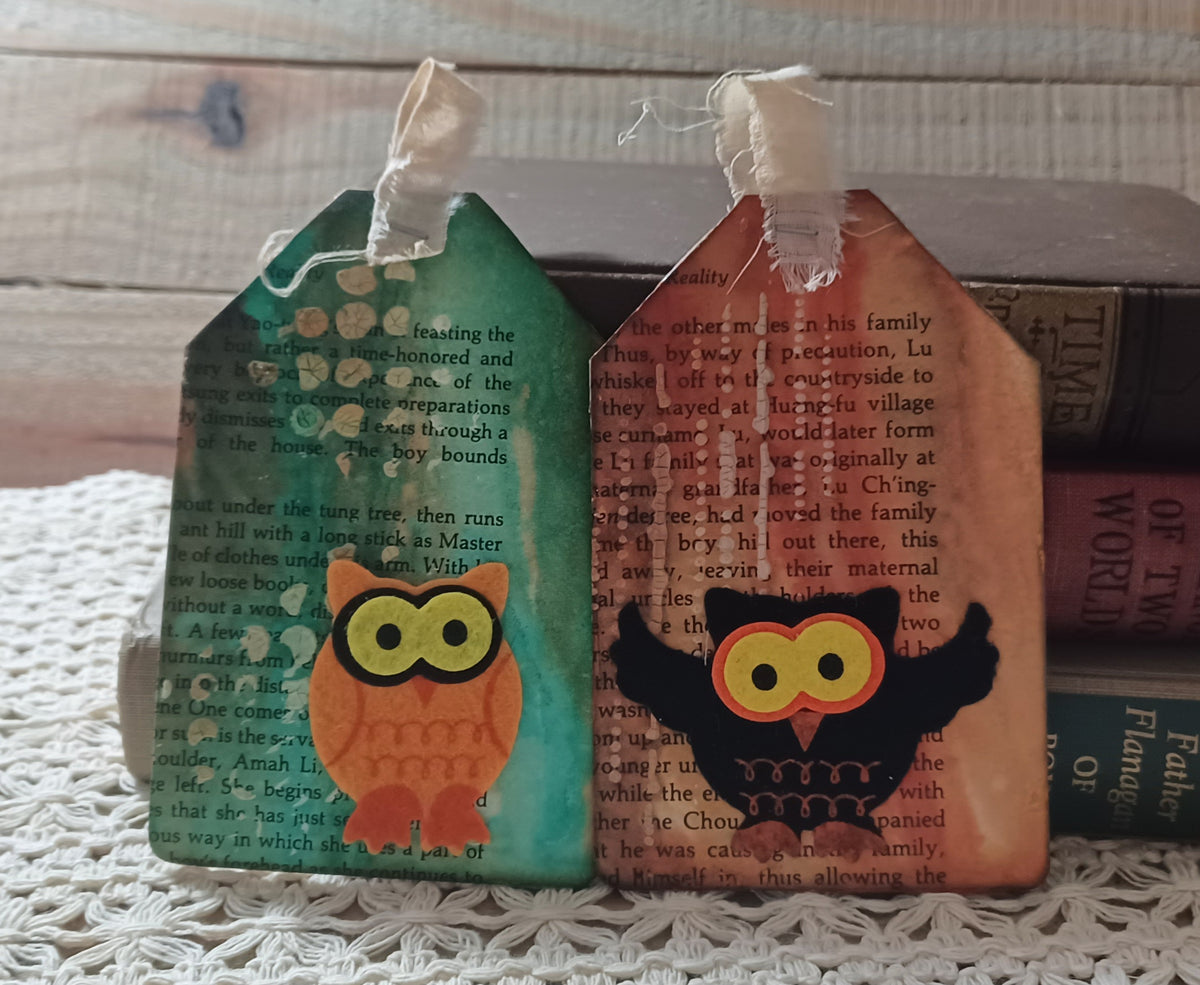 Set of two handmade owl journal tags with emerald turquoise and warm rust backgrounds over vintage book text