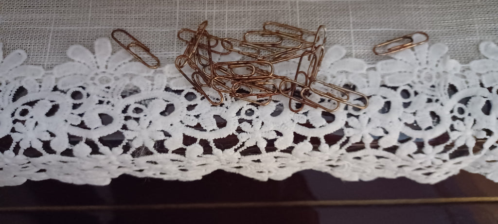 Close-up of 20 faux rust paper clips packaged with a vintage-inspired butterfly and floral backing card.