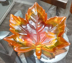 Handmade translucent resin maple leaf trinket dish in orange, red and golden autumn colors