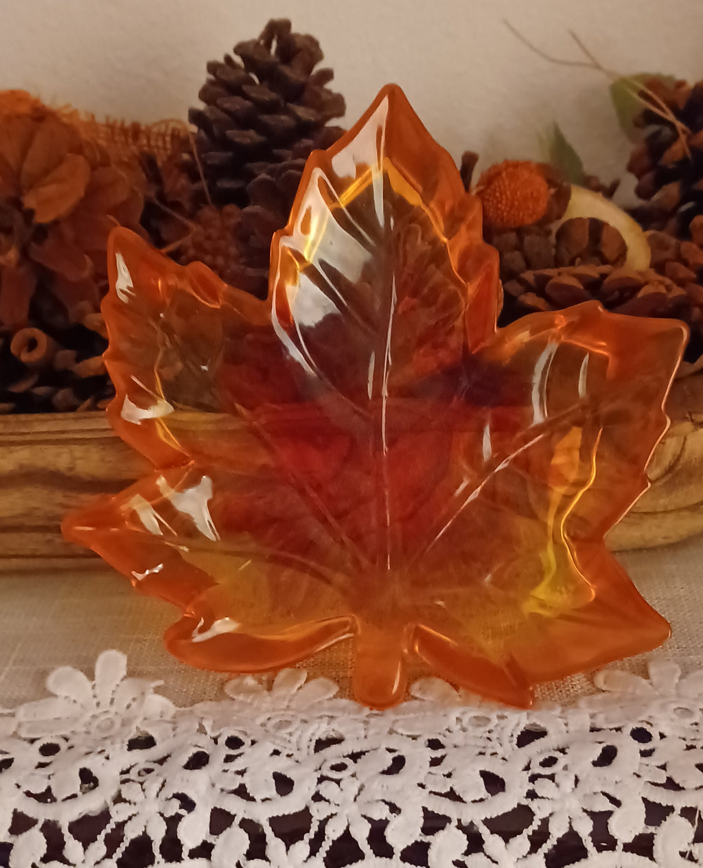 Handmade translucent resin maple leaf trinket dish in orange, red and golden autumn colors